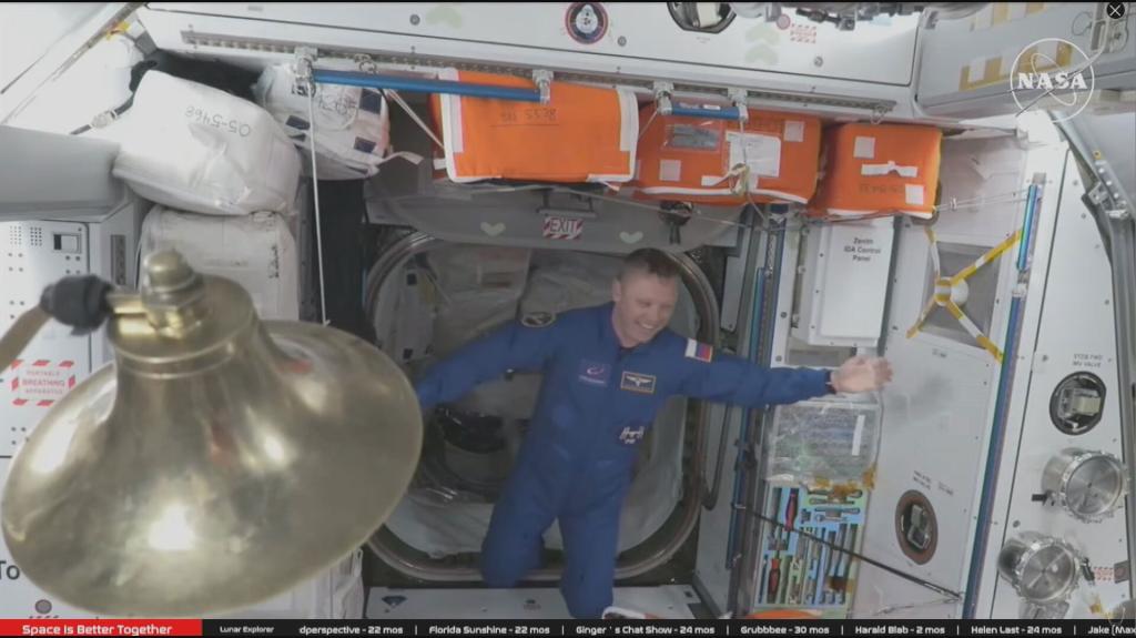 Astronauts celebrating the arrival of the SpaceX Crew Dragon capsule