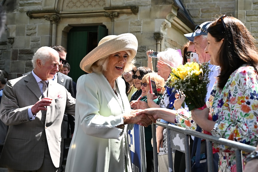 King Charles and Queen Camilla engaging with children