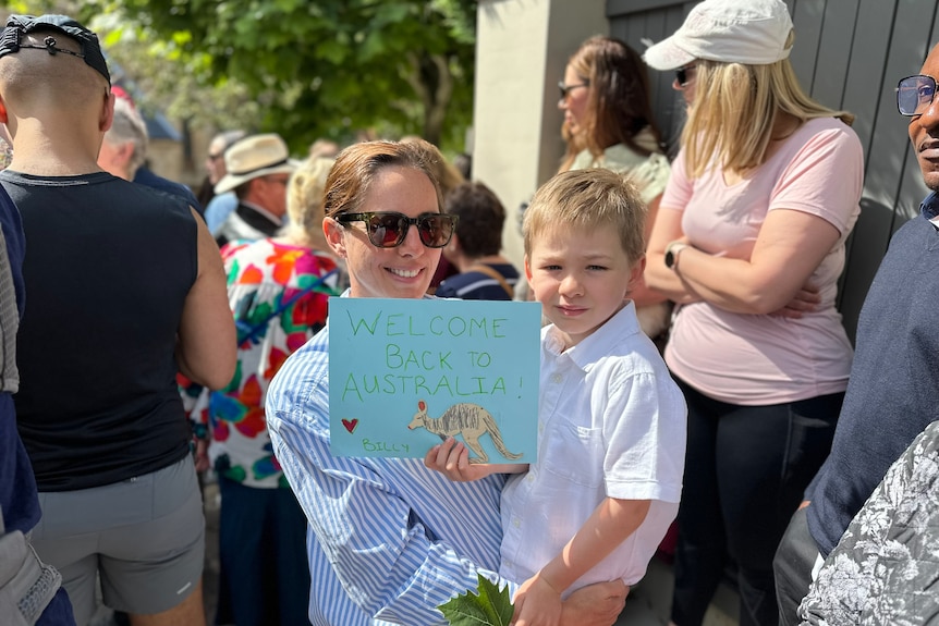 Children waiting to greet King Charles and Queen Camilla